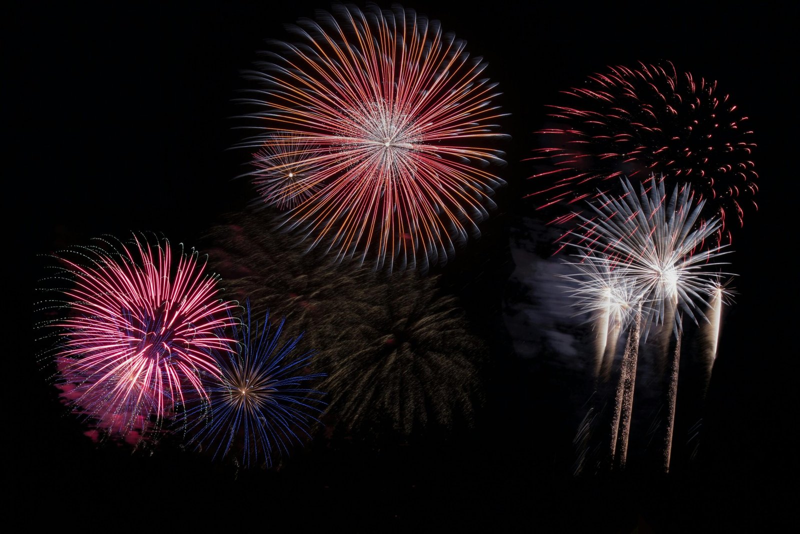 A stunning fireworks display lights up the night sky with vibrant colors.